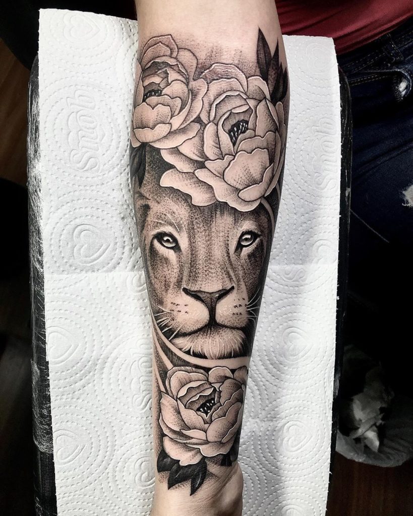 Tatuaż Lew z kwiatami piwonia na przedramieniu znaczenie dla mężczyzn i kobiet
